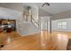 Open living space with hardwood floors, staircase, and access to the kitchen at 106 Windstream Way, Cary, NC 27518