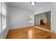 Bright living room featuring hardwood floors and large windows overlooking the backyard at 106 Windstream Way, Cary, NC 27518