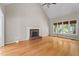 Spacious living room boasting a brick fireplace, hardwood floors, and large windows for plenty of natural light at 106 Windstream Way, Cary, NC 27518