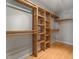 Spacious walk-in closet with custom shelving and wooden floors provides ample storage at 106 Windstream Way, Cary, NC 27518