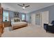 Spacious bedroom featuring a ceiling fan, light-grey walls, and a comfortable bed with bedside tables at 10608 Thornbury Crest Ct Ct, Raleigh, NC 27614