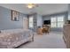 Well-lit bedroom with blue walls, a comfortable bed, a ceiling fan, and a work desk with a chair at 10608 Thornbury Crest Ct Ct, Raleigh, NC 27614