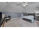 Attic bedroom with sloped ceilings, a dark bed frame, nightstands, and a unique ceiling fan at 10608 Thornbury Crest Ct Ct, Raleigh, NC 27614