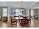 Elegant dining room with hardwood floors, large table, and arched entryway at 10608 Thornbury Crest Ct Ct, Raleigh, NC 27614