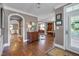 Elegant foyer with hardwood floors, arched doorways, and classic decor at 10608 Thornbury Crest Ct Ct, Raleigh, NC 27614