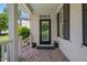 Inviting front porch with a decorative wreath, black door, and potted plants at 10608 Thornbury Crest Ct Ct, Raleigh, NC 27614