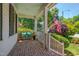 Charming front porch with brick floor, bench with pillows, and an American flag at 10608 Thornbury Crest Ct Ct, Raleigh, NC 27614