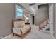 Hallway with seating, window and stairs leading to a upper level; natural light at 10608 Thornbury Crest Ct Ct, Raleigh, NC 27614