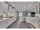 Modern kitchen with white cabinets, granite countertops, and stainless steel appliances at 10608 Thornbury Crest Ct Ct, Raleigh, NC 27614