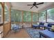 Inviting screened porch with comfortable seating, decorative pillows, and views of the surrounding nature at 10608 Thornbury Crest Ct Ct, Raleigh, NC 27614