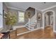 Entryway with stairs featuring hardwood treads, a window, and neutral decor at 10608 Thornbury Crest Ct Ct, Raleigh, NC 27614