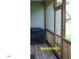Back porch featuring a screen door and patio furniture at 107 Norwood Dr, Clayton, NC 27527