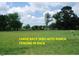 Expansive backyard features lush green lawn, mature trees, and classic white ranch-style fencing at 107 Norwood Dr, Clayton, NC 27527