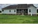 Back exterior view of home featuring a screened-in porch, green lawn and neatly painted siding at 107 Norwood Dr, Clayton, NC 27527