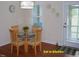 Cozy eat-in kitchen area with a glass-top table, seating for four and a view of the backyard at 107 Norwood Dr, Clayton, NC 27527