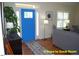 Bright entryway featuring hardwood floors, a vibrant blue front door, and stylish decor at 107 Norwood Dr, Clayton, NC 27527
