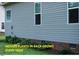Home's exterior featuring light blue vinyl siding and well-maintained landscaping with hostas in front of the house at 107 Norwood Dr, Clayton, NC 27527