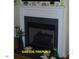 Close-up of a gas fireplace with a decorative mantel and hearth, with stylish accents at 107 Norwood Dr, Clayton, NC 27527