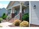 Inviting front entrance with a covered porch, landscaping and steps to front door at 107 Norwood Dr, Clayton, NC 27527