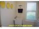 Functional laundry room area with a utility sink, storage and lots of natural light at 107 Norwood Dr, Clayton, NC 27527