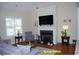 Inviting living room featuring a fireplace, plush seating, and ample natural light at 107 Norwood Dr, Clayton, NC 27527