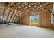 Unfinished attic space with exposed wood beams, perfect for storage at 107 Southern Acres Dr, Fuquay Varina, NC 27526