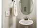 Powder room features a pedestal sink with an oval mirror, decorative accents, and a wall mounted towel holder at 107 Southern Acres Dr, Fuquay Varina, NC 27526