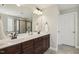 Bathroom featuring a double sink vanity, granite countertops, framed mirror, and a tiled shower with a glass door at 107 Southern Acres Dr, Fuquay Varina, NC 27526