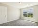 Bedroom featuring a window with a view of a nearby home and yard at 107 Southern Acres Dr, Fuquay Varina, NC 27526