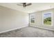 Sun-filled bedroom featuring plush carpet and two windows providing ample natural light at 107 Southern Acres Dr, Fuquay Varina, NC 27526