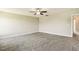 Neutral primary bedroom featuring carpet, ceiling fan, recessed lighting, and doors to the bathroom and hallway at 107 Southern Acres Dr, Fuquay Varina, NC 27526