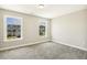 Bedroom featuring two windows with views of a nearby home and yard at 107 Southern Acres Dr, Fuquay Varina, NC 27526
