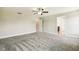 Neutral colored primary bedroom with a ceiling fan, plush carpeting, and doors leading to a bathroom and walk-in closet at 107 Southern Acres Dr, Fuquay Varina, NC 27526