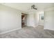 Neutral bedroom with a ceiling fan and closet, perfect for relaxation and storage at 107 Southern Acres Dr, Fuquay Varina, NC 27526