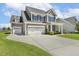 Spacious home with a two-car garage and a well-manicured lawn, offering ample space for outdoor activities at 107 Southern Acres Dr, Fuquay Varina, NC 27526