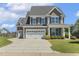 Beautiful two-story home with a gray exterior, two-car garage, and a driveway, showcasing its curb appeal at 107 Southern Acres Dr, Fuquay Varina, NC 27526