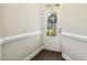 Bright and airy foyer with wood floors and a glass-paneled door, offering a glimpse of the outdoors at 107 Southern Acres Dr, Fuquay Varina, NC 27526