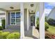 Inviting front porch with white columns and a large window, creating a warm and welcoming entrance at 107 Southern Acres Dr, Fuquay Varina, NC 27526