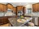 Spacious kitchen with stainless steel appliances, wood cabinetry, granite countertops, and an island at 107 Southern Acres Dr, Fuquay Varina, NC 27526