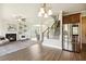 Open concept living area with a fireplace, stairs to the second floor, and stainless steel refrigerator at 107 Southern Acres Dr, Fuquay Varina, NC 27526