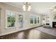 Bright and airy living room with a fireplace, built-in shelving, and a large window overlooking the backyard at 107 Southern Acres Dr, Fuquay Varina, NC 27526