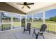 Relaxing screened-in porch featuring a ceiling fan, patio furniture, and views of the backyard at 107 Southern Acres Dr, Fuquay Varina, NC 27526