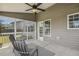 Cozy screened-in porch featuring a ceiling fan, and gray Adirondack chairs for outdoor relaxation at 107 Southern Acres Dr, Fuquay Varina, NC 27526
