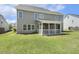Back of house showcasing a screened porch, and a well-maintained lawn at 107 Southern Acres Dr, Fuquay Varina, NC 27526