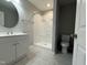 Bright bathroom featuring a vanity, toilet, and tub/shower with a neutral color scheme and updated fixtures at 109 Pine St, Dunn, NC 28334