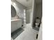 Bright bathroom with white vanity, framed mirror, walk-in shower, and tile flooring at 109 Pine St, Dunn, NC 28334