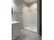 Shower stall with bright white walls, gray floor, and vanity with a towel bar at 109 Pine St, Dunn, NC 28334