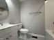 Clean bathroom with white fixtures, updated vanity, toilet, and shower/tub, complemented by neutral-toned walls and flooring at 109 Pine St, Dunn, NC 28334