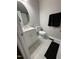 Well-lit bathroom featuring a large, round mirror, modern fixtures and a tile floor at 109 Pine St, Dunn, NC 28334