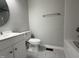 Clean bathroom with white fixtures, updated vanity, toilet, and shower/tub, complemented by neutral-toned walls and flooring at 109 Pine St, Dunn, NC 28334